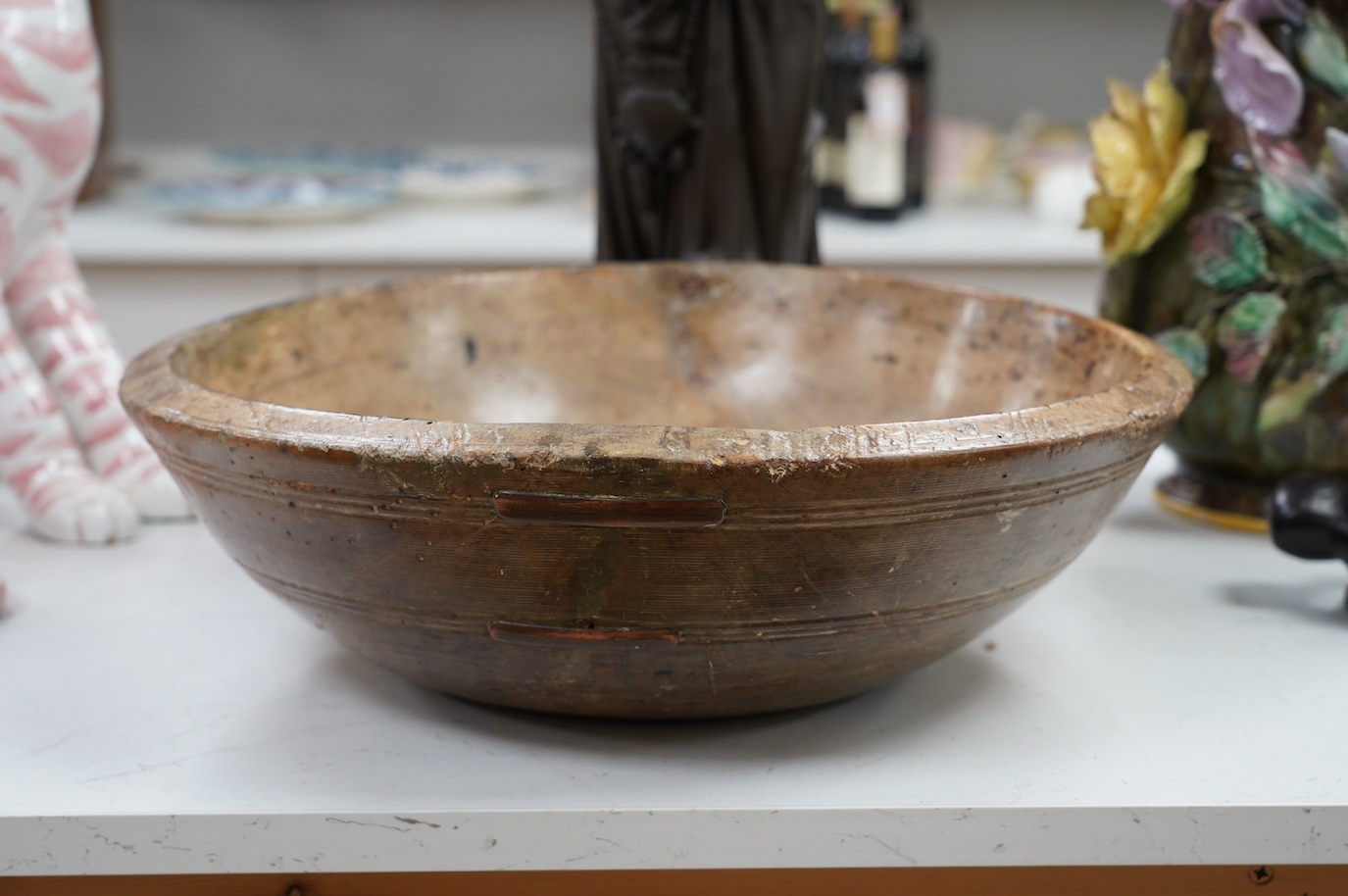 An 18th/19th century sycamore mixing bowl and a smaller bowl, largest 44cm diameter. Condition - poor